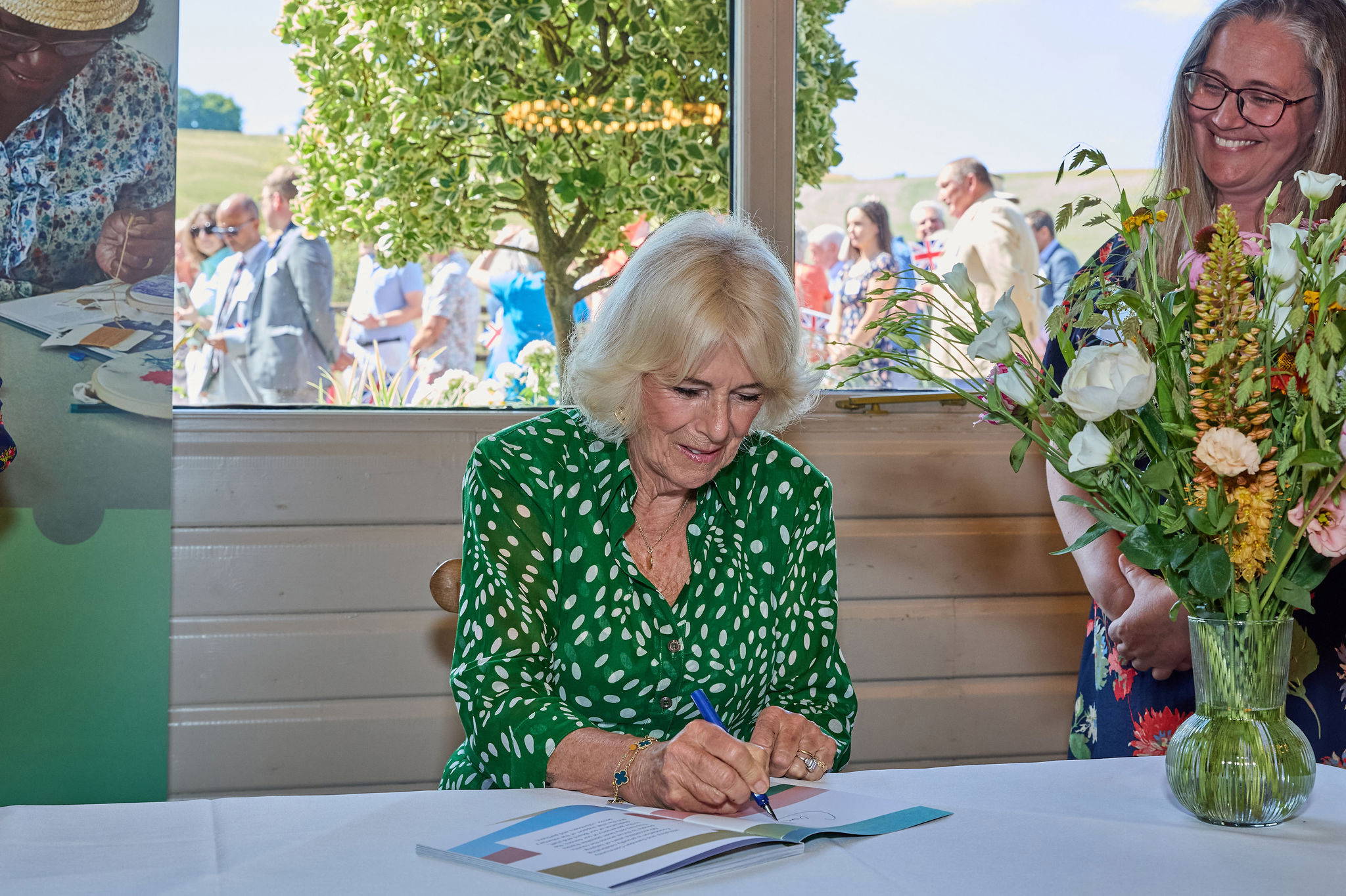 Her Majesty Queen Camilla signing a book Her Majesty Queen Camilla signing a book